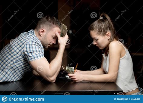 husband and wife sadly consider remaining money in a difficult economic