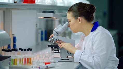 female scientist  microscope  lab stock footage sbv