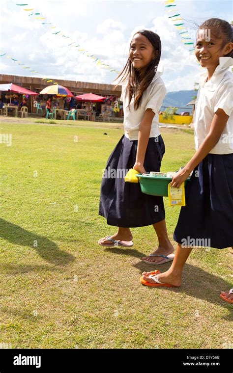 Girls Carrying Dishes At The Bottom Of The Volcano Taal In The