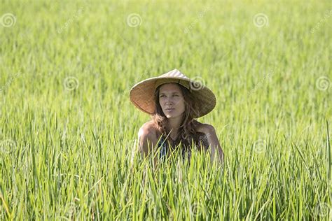 Portrait Girl In A Straw Hat Against The Backdrop Of A Rice Field In