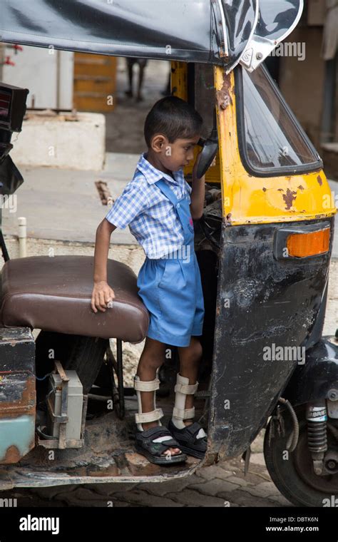 small indian boy plays  autorickshaw crippled leg braces stock photo  alamy