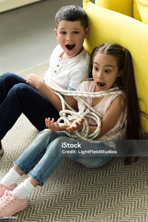 Tied With Rope Sister And Brother Sitting On Floor And Screaming At