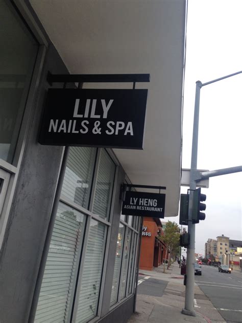 street sign  reads lily nails  spa   side   building