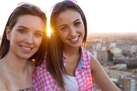 Free Photo Two Gorgeous Girls With City On Background