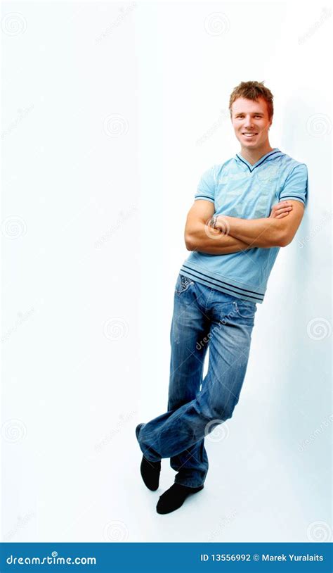 cheerful young man leaning  wall stock photo image  modern happy