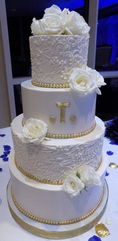 4 tier buttercream wedding cake decorated with buttercream