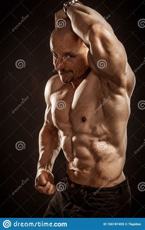 Fitness Portrait Of Bald Shirtless Male Bodybuilder With