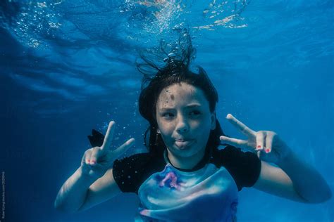 Young Preteen Girl Having Fun Swimming In A Pool Underwater By Robert