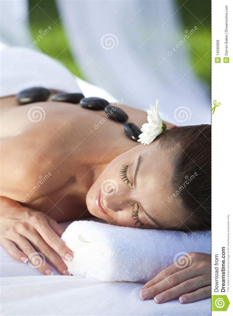 Woman At Health Spa Having Hot Stone Treatment Royalty