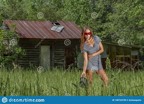 lovely brunette bikini model posing outdoors in a rural environment