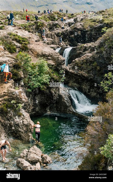 tourists swim  clamber  waterfalls  rocks   fairy pools