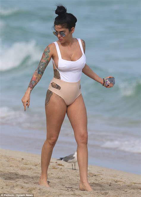 cbb s cami li shows off heavily tattooed bottom in thong style swimsuit