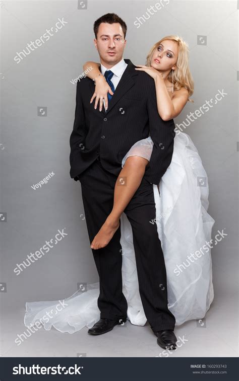 wedding day portrait of happy married couple sexy blonde bride and