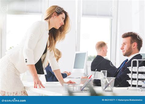Secretary Leaning Seductively At Co Worker`s Desk Stock Image Image