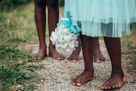 black flower girl s feet on a path outdoors by stocksy contributor