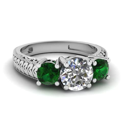vintage engraved 3 stone engagement ring with emerald in