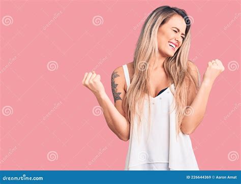 Young Beautiful Blonde Woman Wearing Sleeveless T Shirt Very Happy And