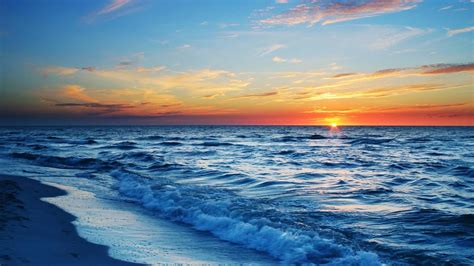 sun  setting   ocean  waves