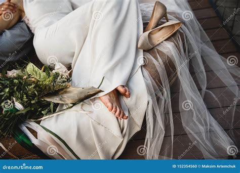bride  laying   couch barefoot  shoes  laying     wearing  white