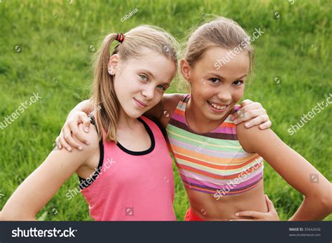 Happy Preteen Girls Friendly Hugging On Green Grass 5202 The Best