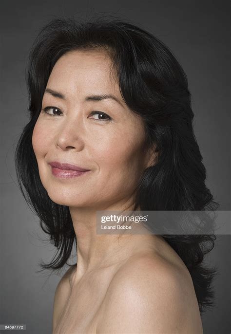 portrait of mature japanese woman bare shoulders stock