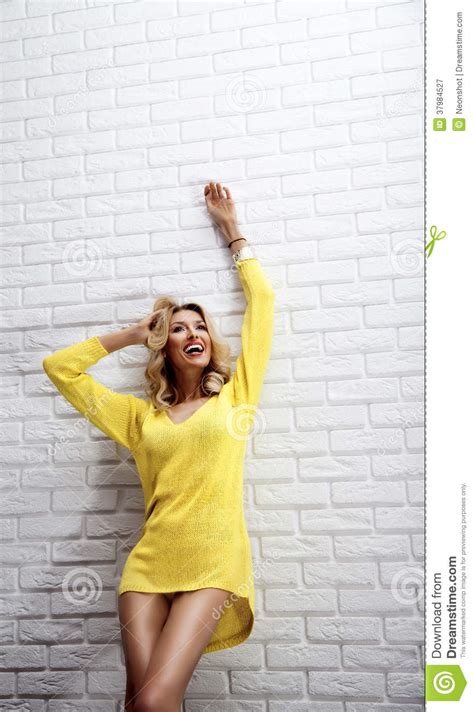 happy blonde woman posing with toothy smile stock image