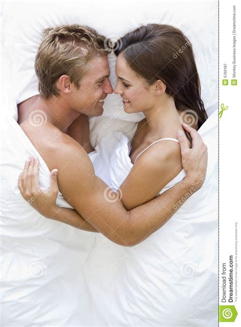couple lying in bed smiling stock image image of head above 5760187