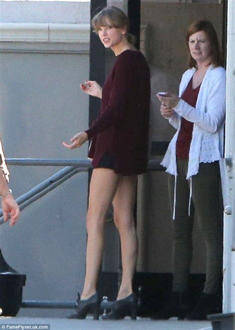 taylor swift shows off long legs in maroon sweater and not much else