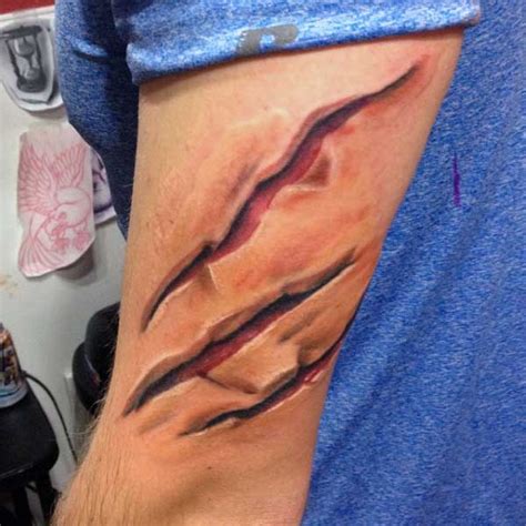 ripped skin tattoo designs  men manly torn flesh ink