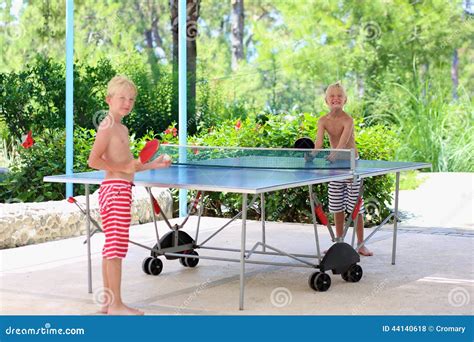 happy boys playing ping pong outdoors stock photo image  friends enjoy
