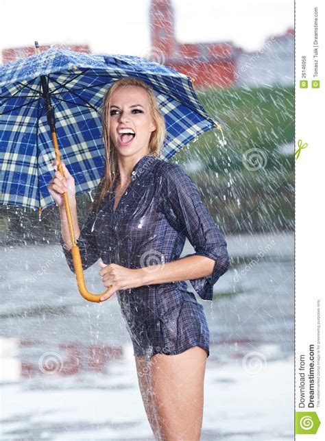 woman with blue umbrella on rainy day royalty free stock