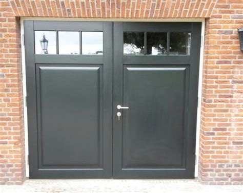 Two Black Double Doors In Front Of A Brick Building