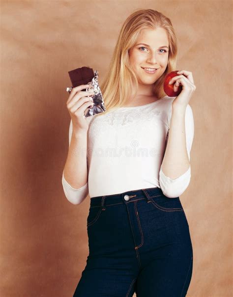 Young Beauty Blond Teenage Girl Eating Chocolate Smiling Choice