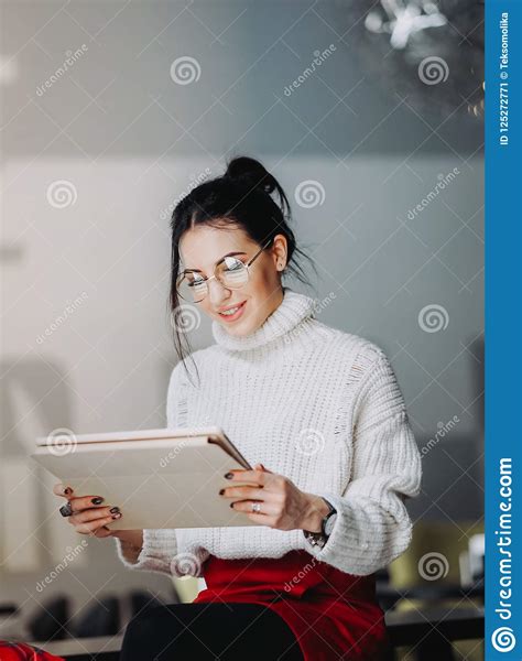 brunette woman with eyeglasses using tablet stock image