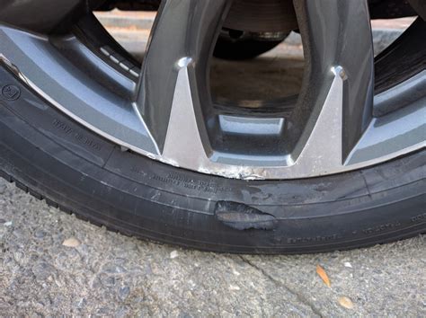 mazda hit  curb chewed  rim    chunk   tire    replacement