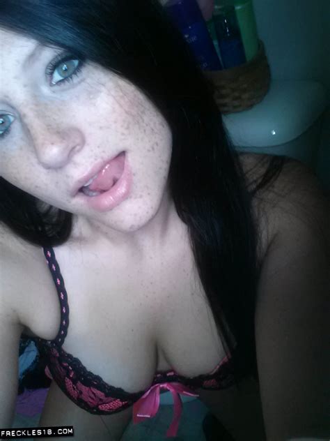 self shot of amateur freckles in stockings and sexy lingerie showing tongue