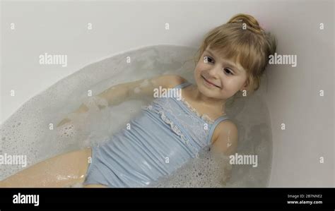 Attractive Four Years Old Girl Takes A Bath In Swimwear Hygiene For