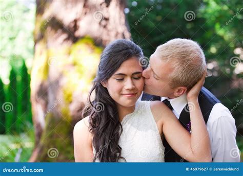 Caucasian Groom Lovingly Kissing His Biracial Bride On Cheek Di Stock