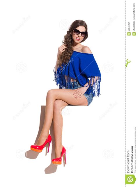 Charming Girl Sitting With Legs Crossed At Knee Stock