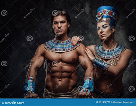 Woman In Traditional Egyptian Costume Holds Male Shoulder With Both Of