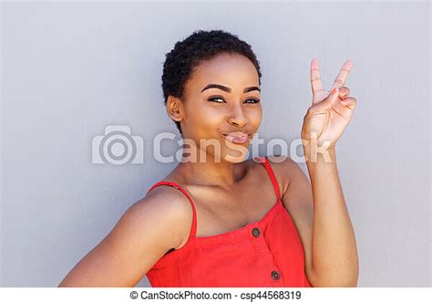 portrait  beautiful young black woman  peace sign hand gesture canstock