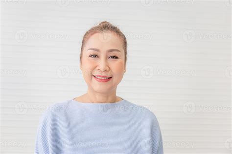 Portrait Of Happy Asian Woman In Living Room Relaxing Mature Middle