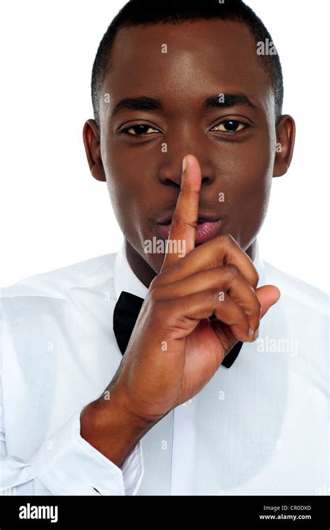 black man showing silence gesture  finger   lips   white