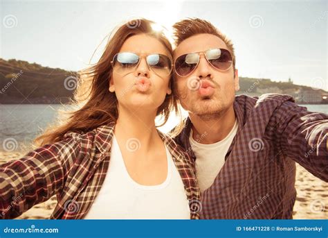 Couple In Love Making Selfie Photo At The Seaside With Kiss Close Up