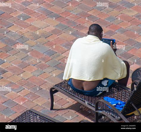 Black Man Exposing His Butt Crack While Sitting On Lounge Chair Stock