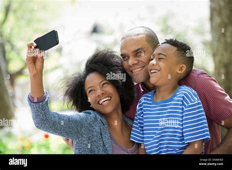 adults   young boy  photographs   smart phone stock