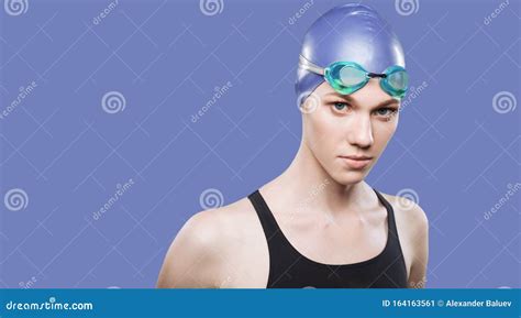 Woman Swimmer In Swimming Cap And Goggles On Her Head Look At The