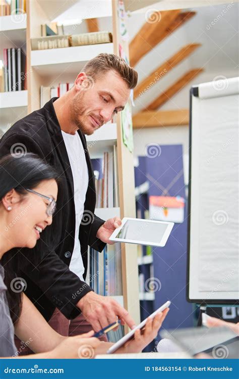 teacher  tablet computer helps  student stock photo image  technology