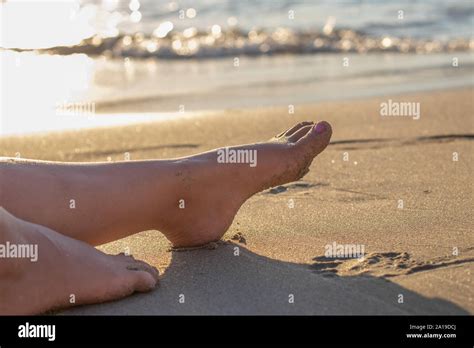 hot girl  beautiful legs lying   sandy beach sunbathing