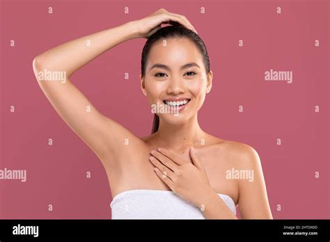 Cheerful Japanese Woman Showing Her Clean And Hairless Armpit Stock